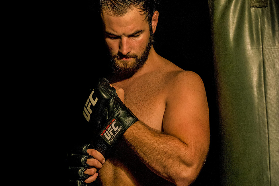 man putting on fighting gloves