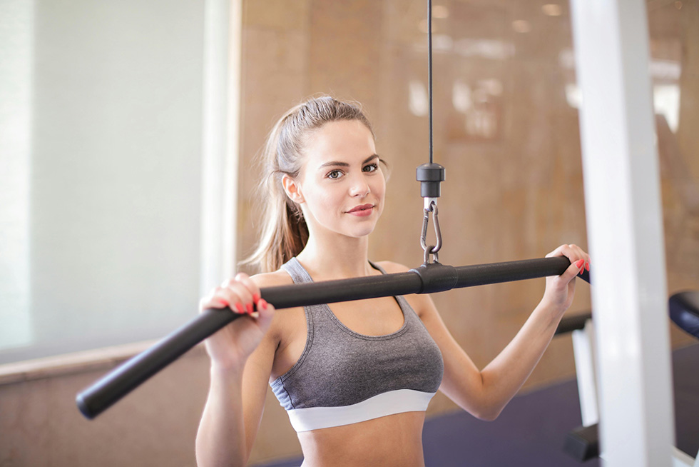 woman exercising arms at gym