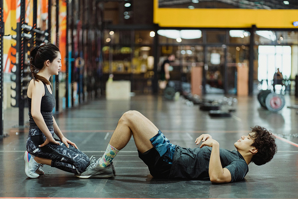 trainer with gym member